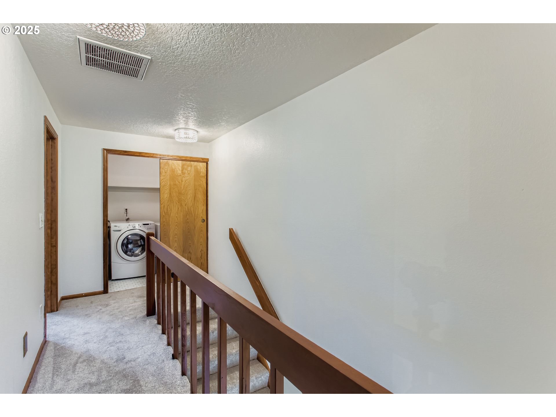 3248 Northeast 29th Street Gresham, OR 97030 - Photo 29 of 40 a view of a hallway with wooden floor and stairs