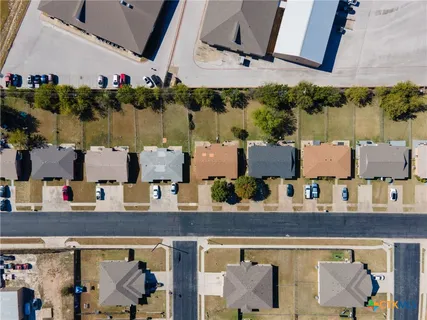 an aerial view of multiple houses with outdoor space