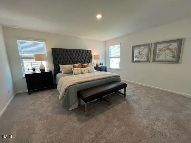 a bedroom with a bed and a night stand