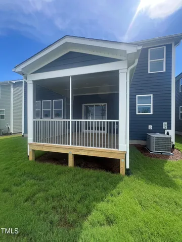 a view of a house with a backyard and deck
