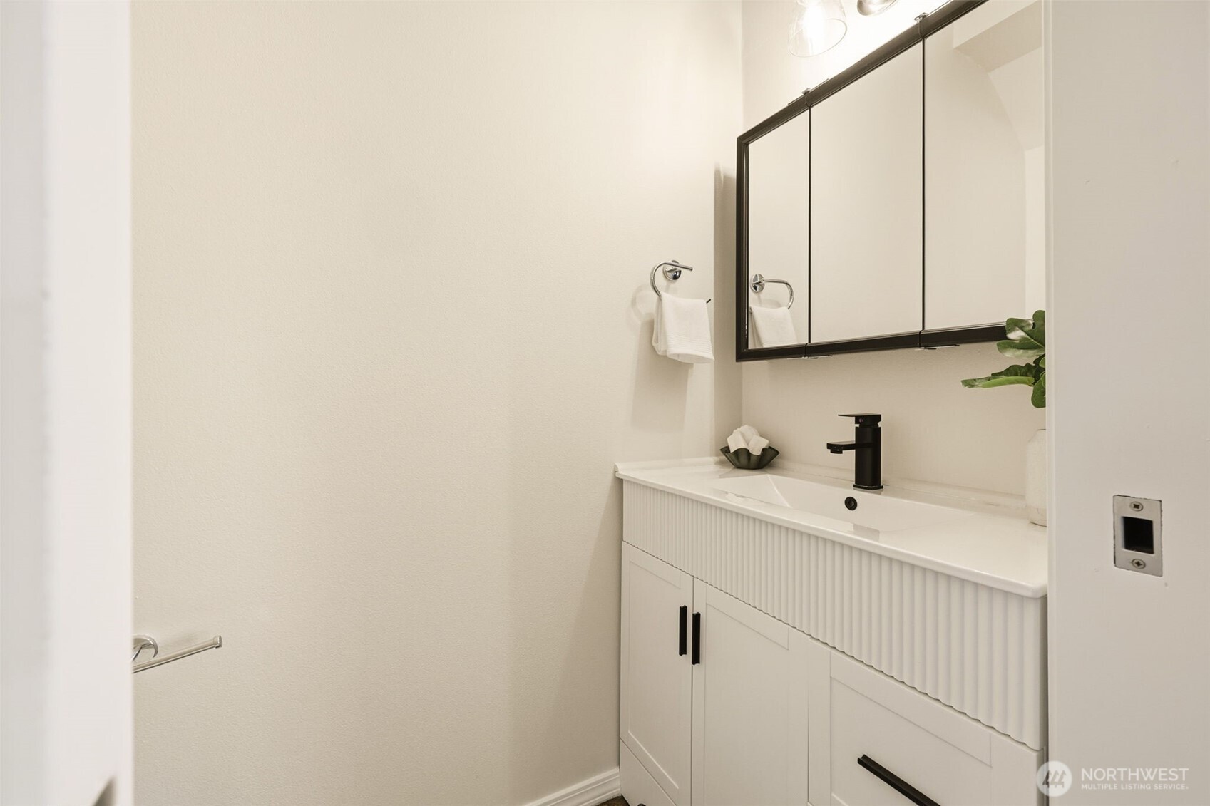 8847 9th Avenue Southwest, Unit A Seattle, WA 98106 - Photo 15 of 31 a bathroom with a sink and a mirror