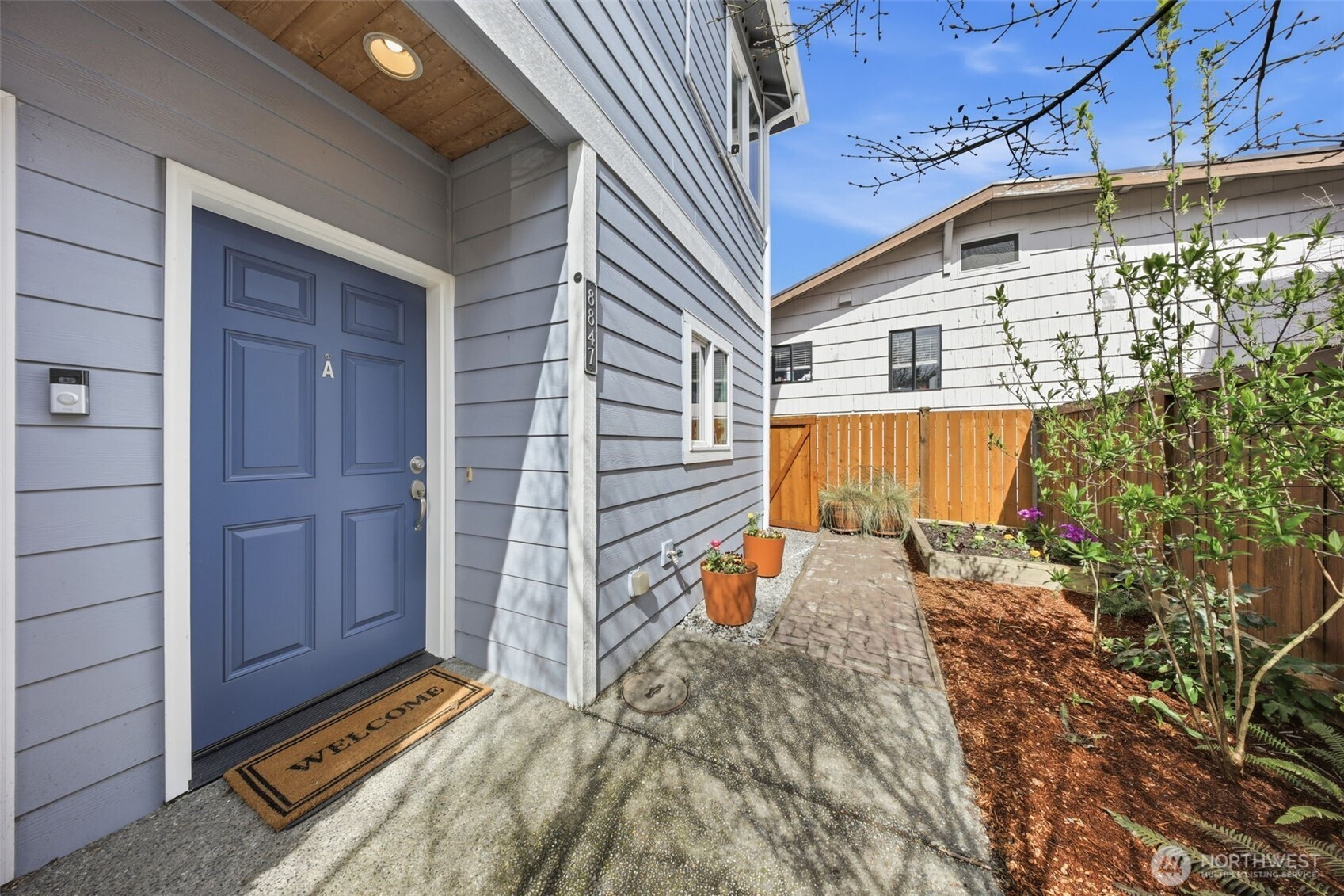 8847 9th Avenue Southwest, Unit A Seattle, WA 98106 - Photo 2 of 31 a view of a backyard with a small cabin and wooden fence