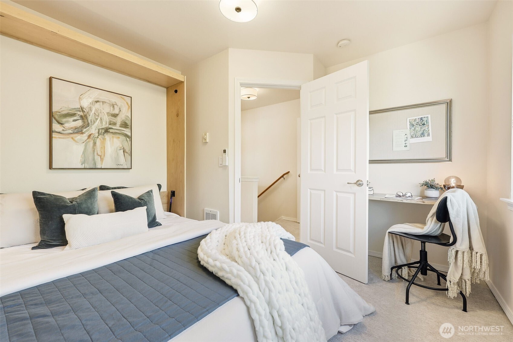 8847 9th Avenue Southwest, Unit A Seattle, WA 98106 - Photo 21 of 31 a bedroom with a bed and a chair