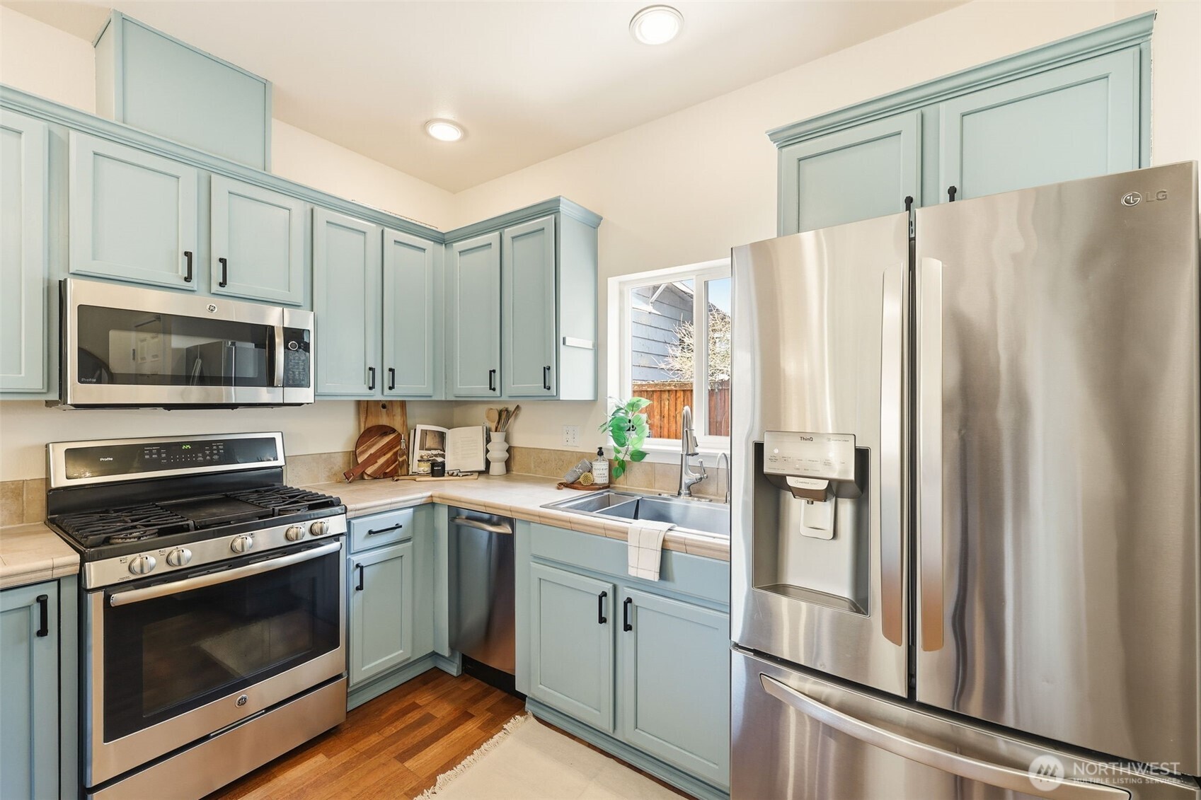 8847 9th Avenue Southwest, Unit A Seattle, WA 98106 - Photo 7 of 31 a kitchen with cabinets stainless steel appliances and sink