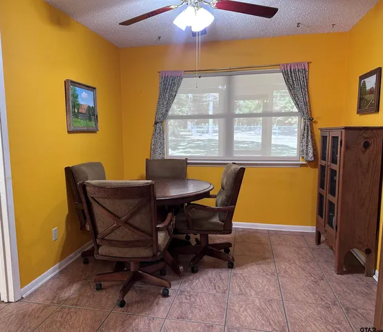 a dining room with a table and chairs