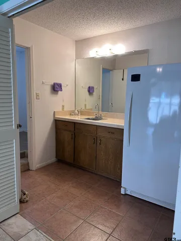 a spacious bathroom with a double vanity sink a and mirror