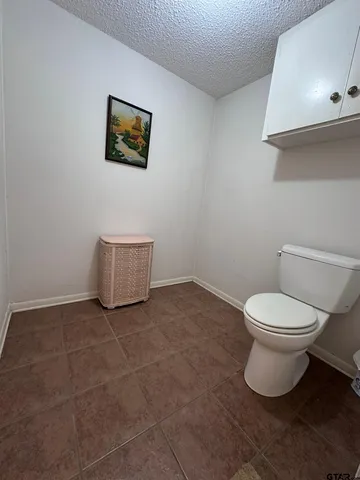a white toilet sitting next to a bathroom sink