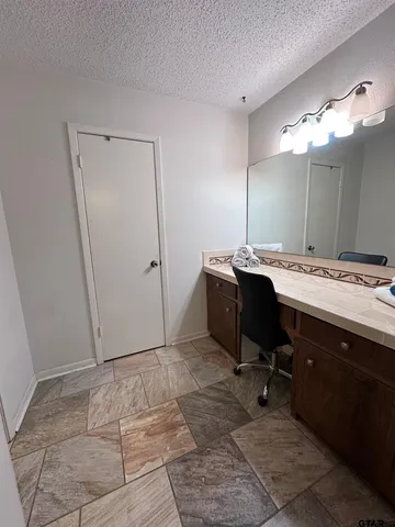 a room with a table chairs and mirrors