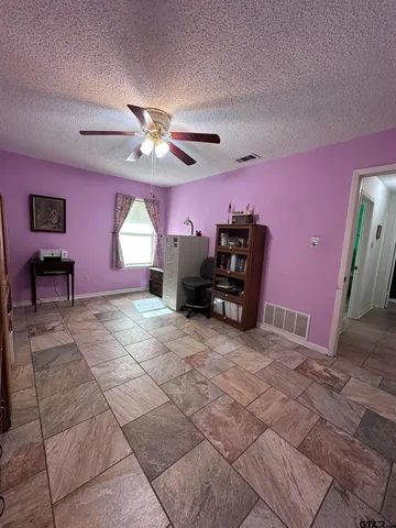 a view of a livingroom with furniture and a chandelier fan