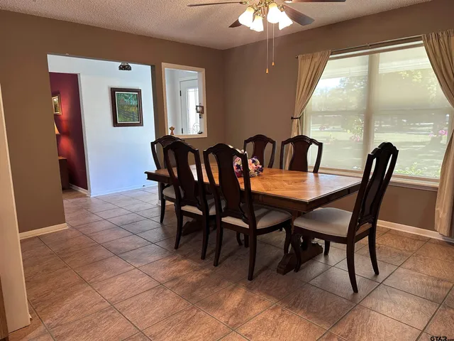 a view of a dining room with furniture large windows and wooden floor
