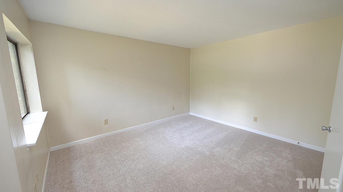 612 Pine Ridge Place, Unit 612 Raleigh, NC 27609 - Photo 6 of 12 an empty room with a window