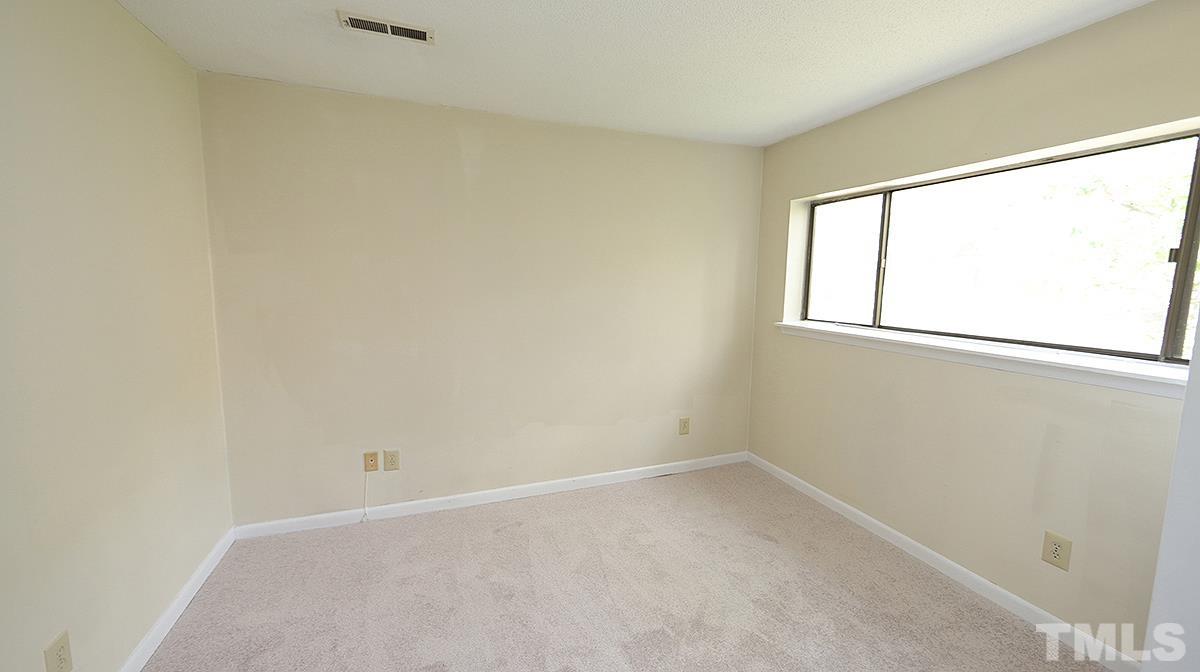 612 Pine Ridge Place, Unit 612 Raleigh, NC 27609 - Photo 8 of 12 an empty room with a window