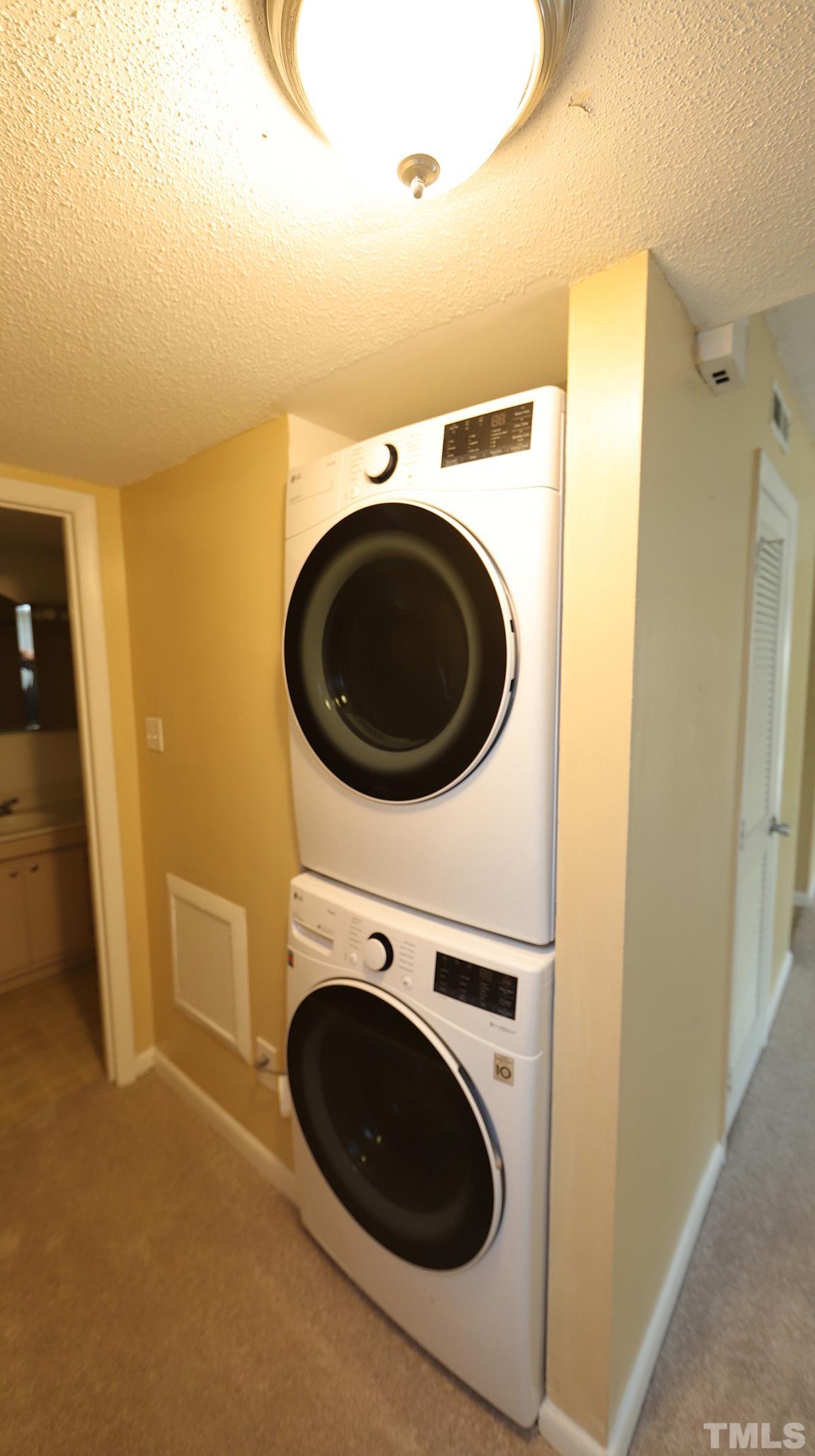 612 Pine Ridge Place, Unit 612 Raleigh, NC 27609 - Photo 9 of 12 a utility room with dryer and washer