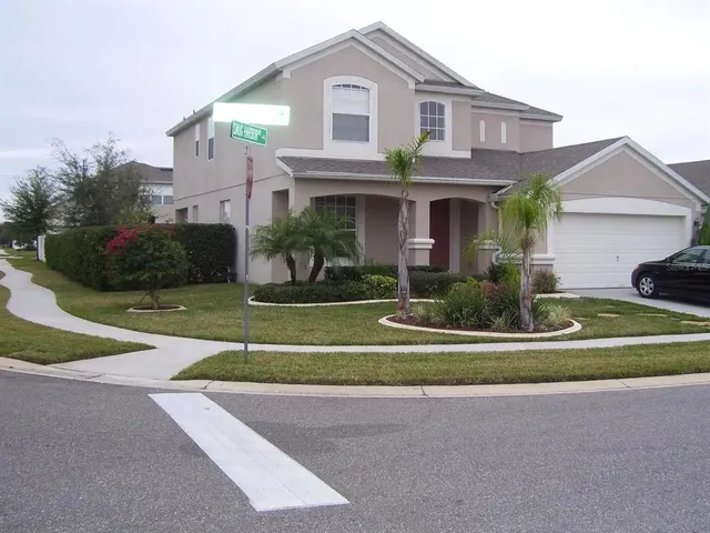 a front view of a house with a yard and a garage