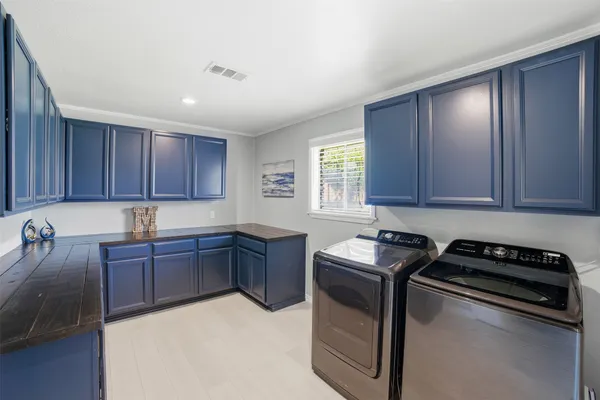 a kitchen with sink window and cabinets