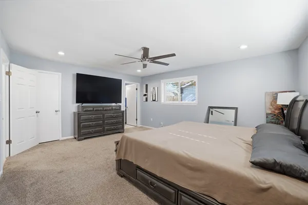 a bedroom with a bed and a flat screen tv