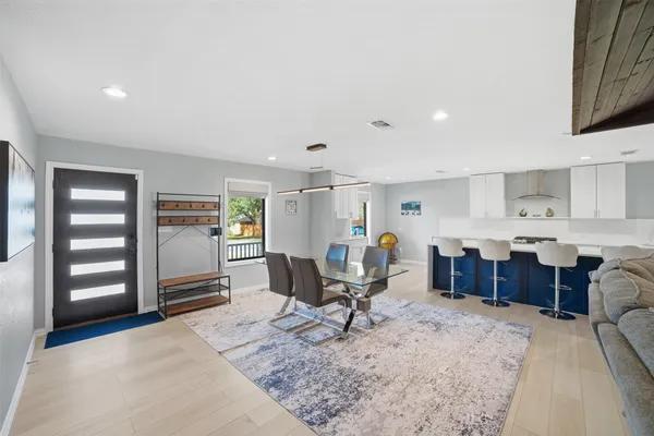 a living room with furniture a dining table and kitchen view