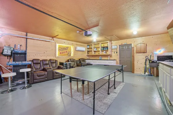 a dining hall with stainless steel appliances granite countertop a stove and a refrigerator
