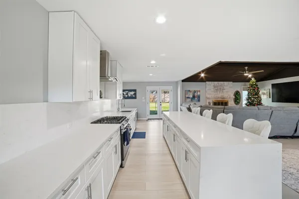 a large white kitchen with a lot of counter space