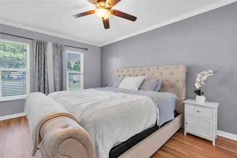 a bedroom with a bed and a chandelier