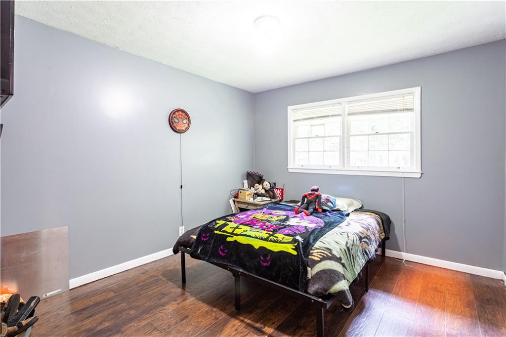 1535 Flat Shoals Road Southwest Conyers, GA 30094 - Photo 11 of 21 a bedroom with a bed and a window