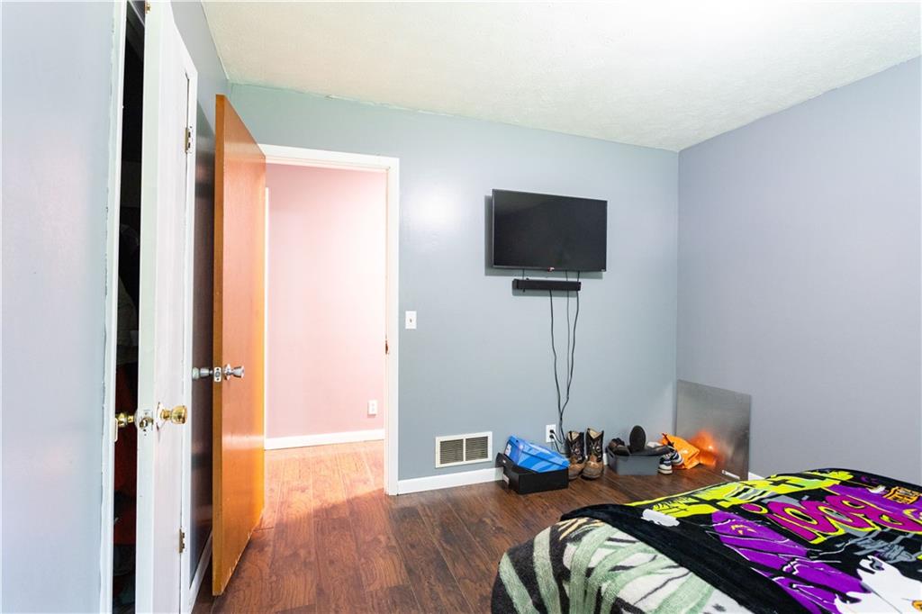 1535 Flat Shoals Road Southwest Conyers, GA 30094 - Photo 13 of 21 a bedroom with bed and a tv