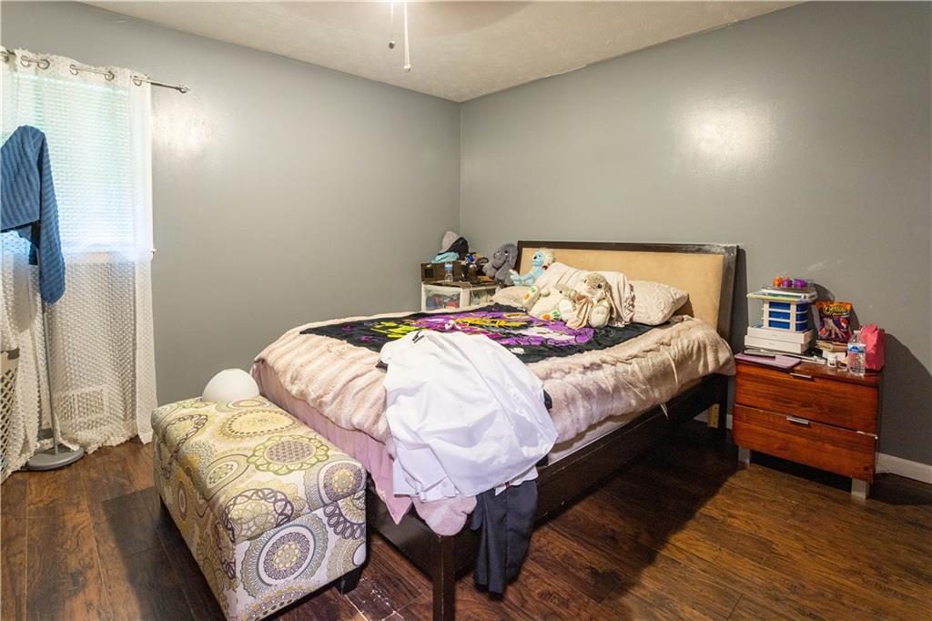 1535 Flat Shoals Road Southwest Conyers, GA 30094 - Photo 16 of 21 a bedroom with a bed and a mirror