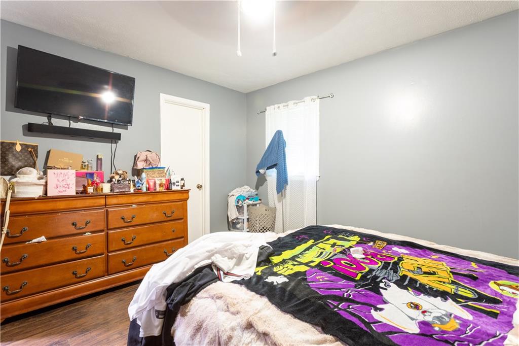 1535 Flat Shoals Road Southwest Conyers, GA 30094 - Photo 17 of 21 a bed room with a bed a flat screen tv and a window