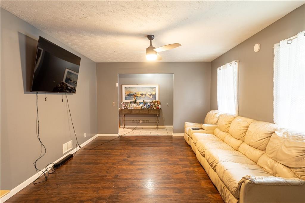 1535 Flat Shoals Road Southwest Conyers, GA 30094 - Photo 3 of 21 a spacious bedroom with a bed and a flat screen tv