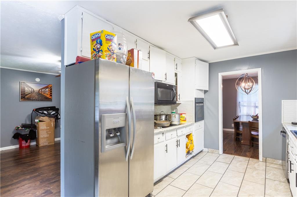 1535 Flat Shoals Road Southwest Conyers, GA 30094 - Photo 5 of 21 a kitchen with stainless steel appliances a refrigerator and a stove