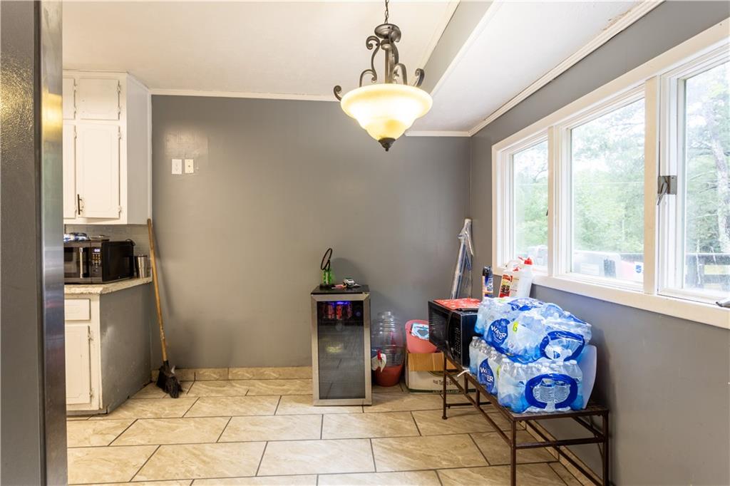 1535 Flat Shoals Road Southwest Conyers, GA 30094 - Photo 6 of 21 a view of a dining room with furniture window and outside view