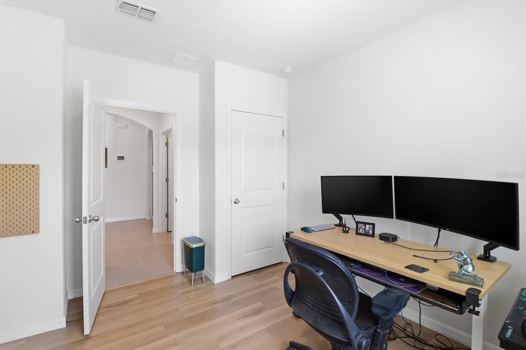 660 Hickory Course Loop Ocala, FL 34472 - Photo 27 of 45 a view of workspace with wooden floor and flat screen tv