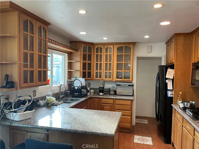 a kitchen with granite countertop wooden cabinets and stainless steel appliances