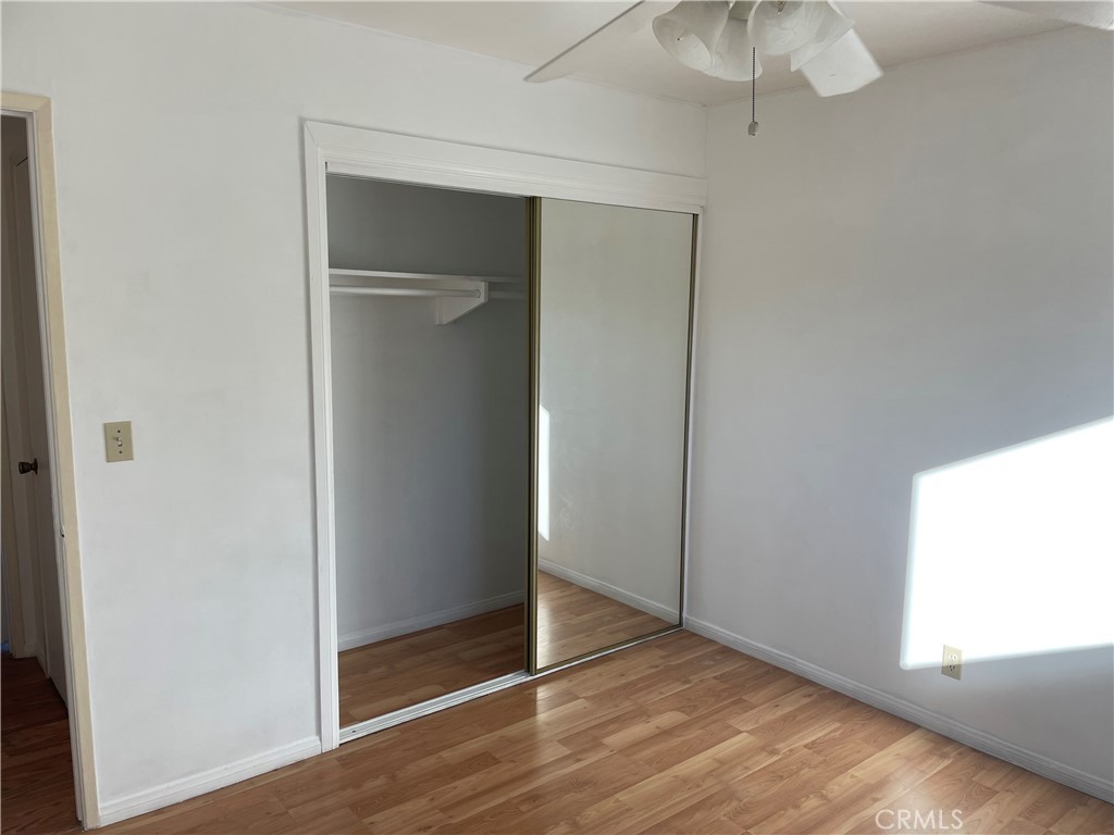 825 Sonora Road Costa Mesa, CA 92626 - Photo 18 of 37 an empty room with wooden floor cabinet and windows