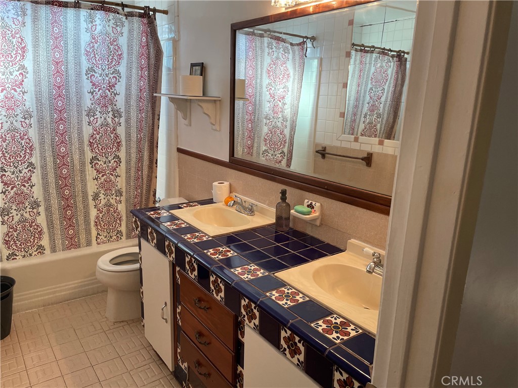 825 Sonora Road Costa Mesa, CA 92626 - Photo 21 of 37 a bathroom with a granite countertop sink toilet and shower