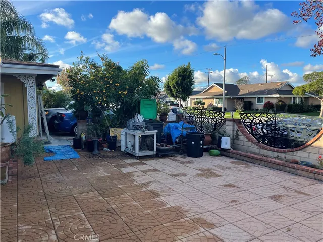 a view of a chair and tables in the patio of the house