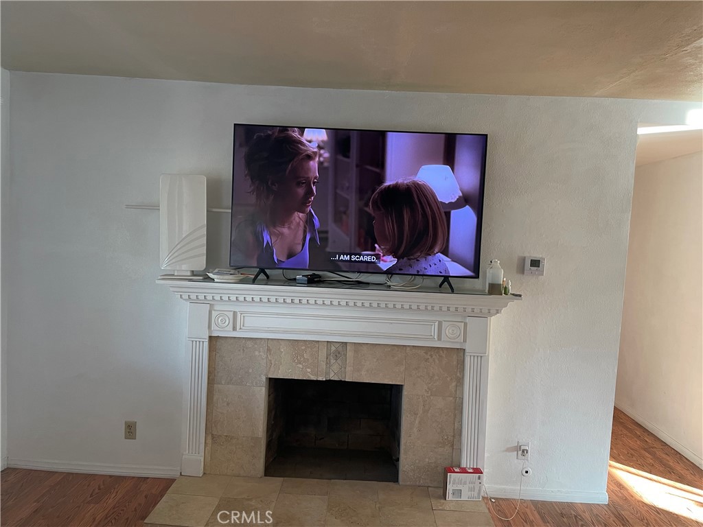 825 Sonora Road Costa Mesa, CA 92626 - Photo 8 of 37 a living room with furniture and a fireplace