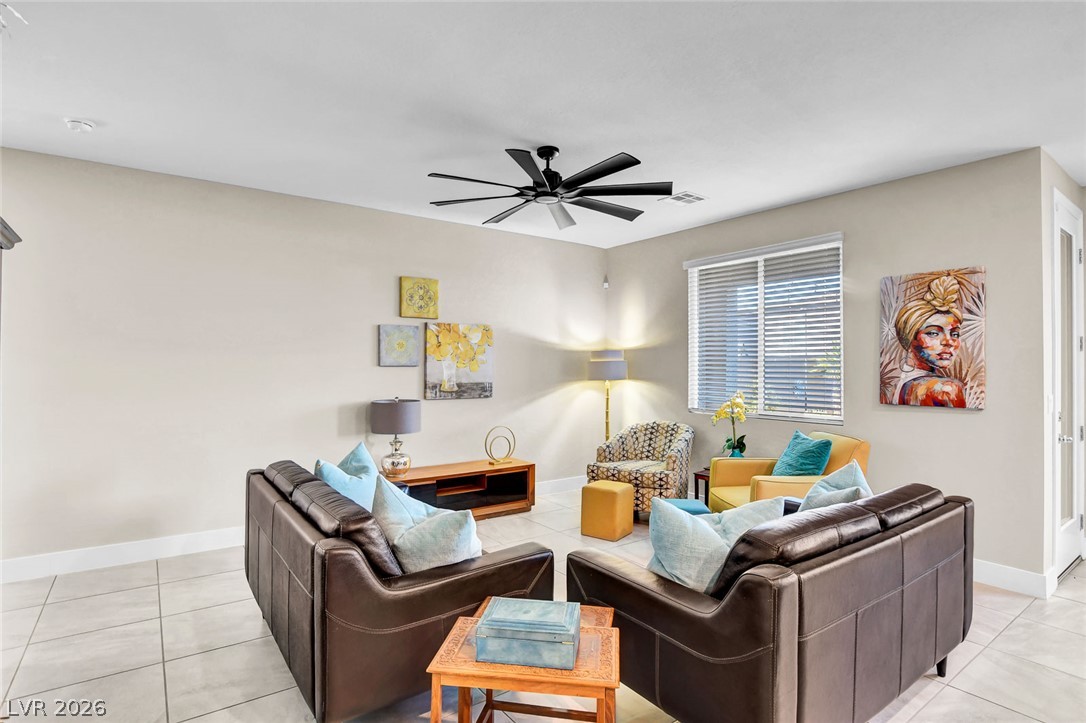 9688 Rankin Rdg Court Las Vegas, NV 89178 - Photo 7 of 53 Well-lit living room with tiled flooring and a modern ceiling fan for optimal comfort.