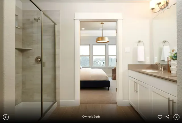 a en suite bathroom with a granite countertop sink a toilet and shower