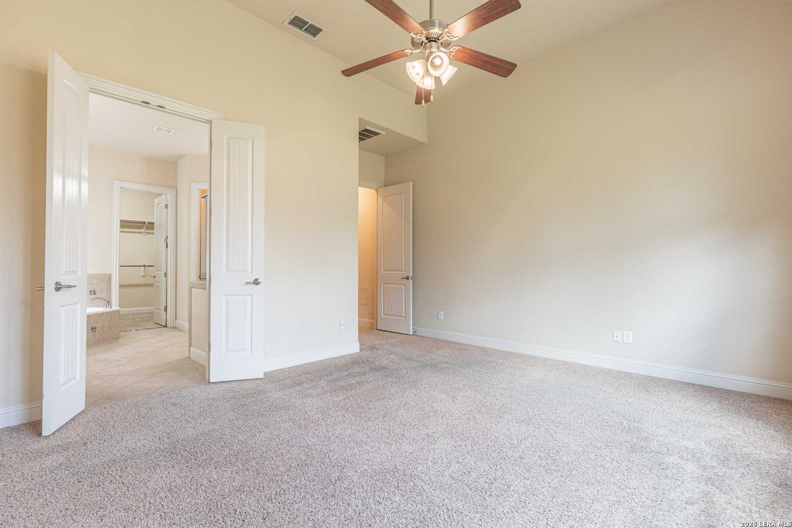 8103 Mystic Chase Boerne, TX 78015 - Photo 23 of 49 an empty room with a bathroom and a chandelier fan