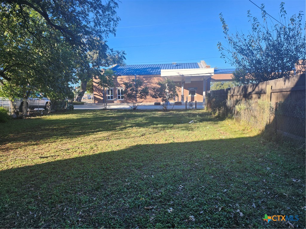906 South Chestnut Street Lampasas, TX 76550 - Photo 4 of 5 a view of a swimming pool with an outdoor space and seating area