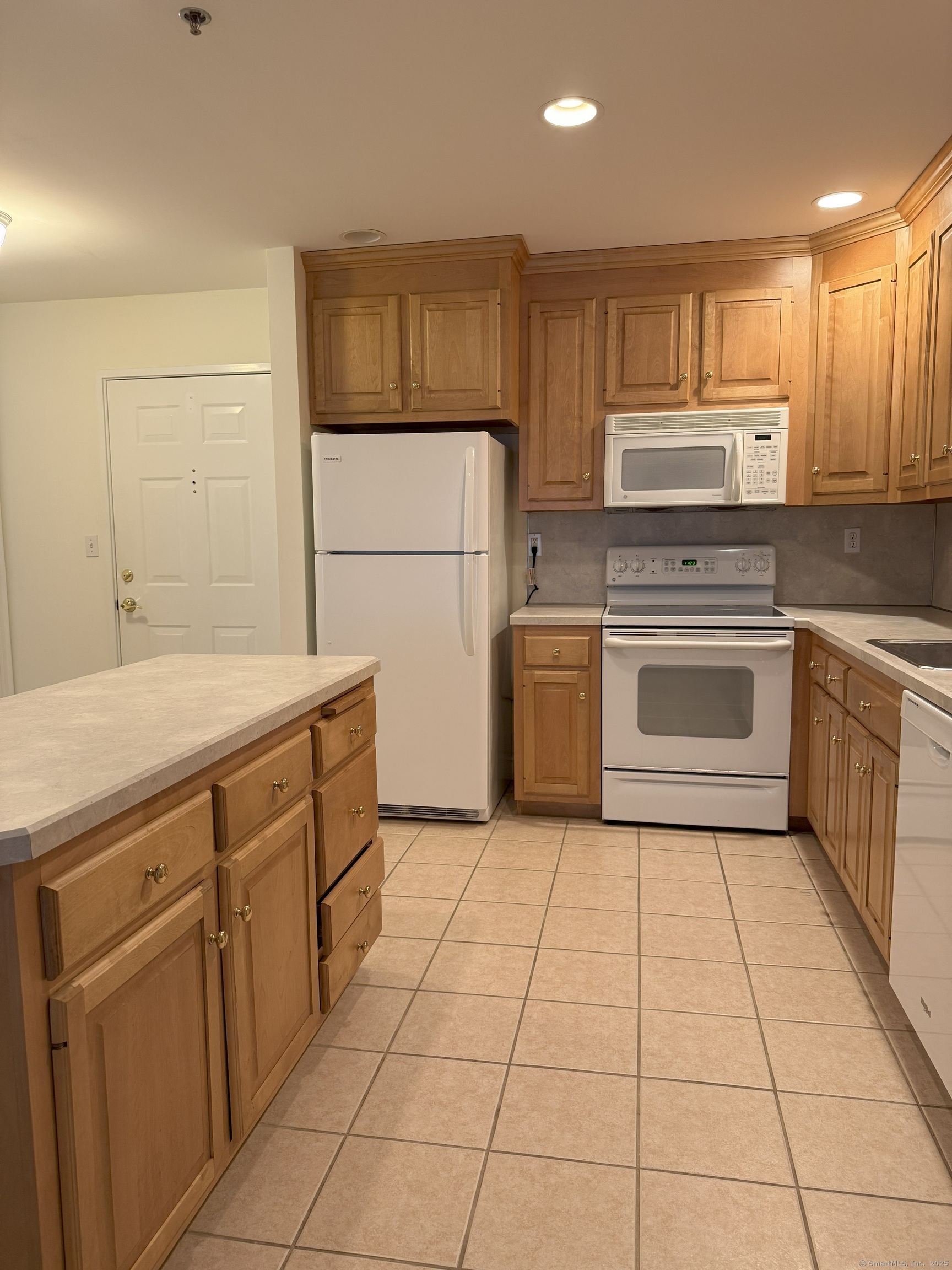 380 Main Street, Unit 13 Wallingford, CT 06492 - Photo 3 of 5 a kitchen with stainless steel appliances granite countertop a stove a sink and a refrigerator