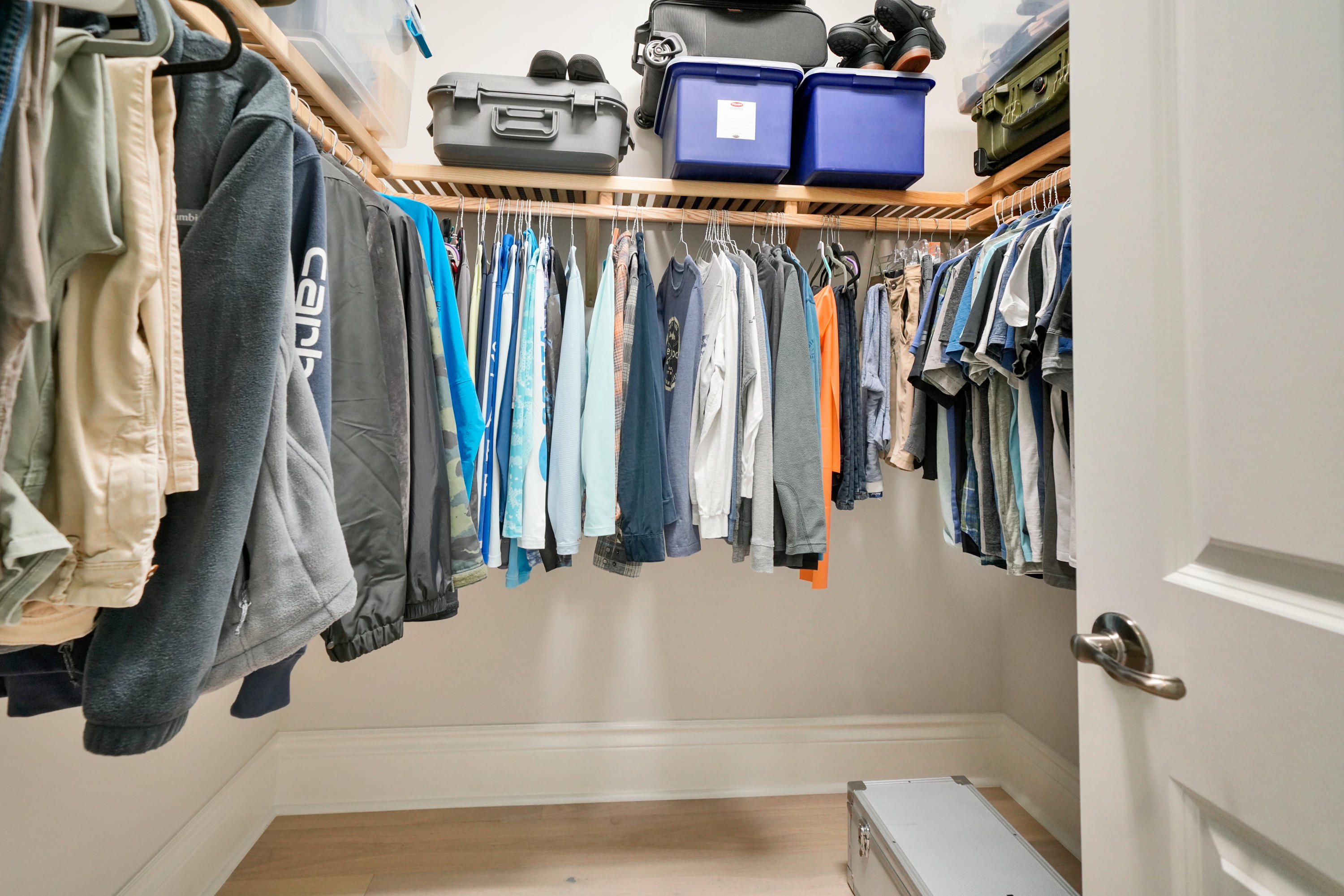 16127 Cadence Pass Jupiter, FL 33478 - Photo 37 of 59 a view of walk in closet with clothes and shoes