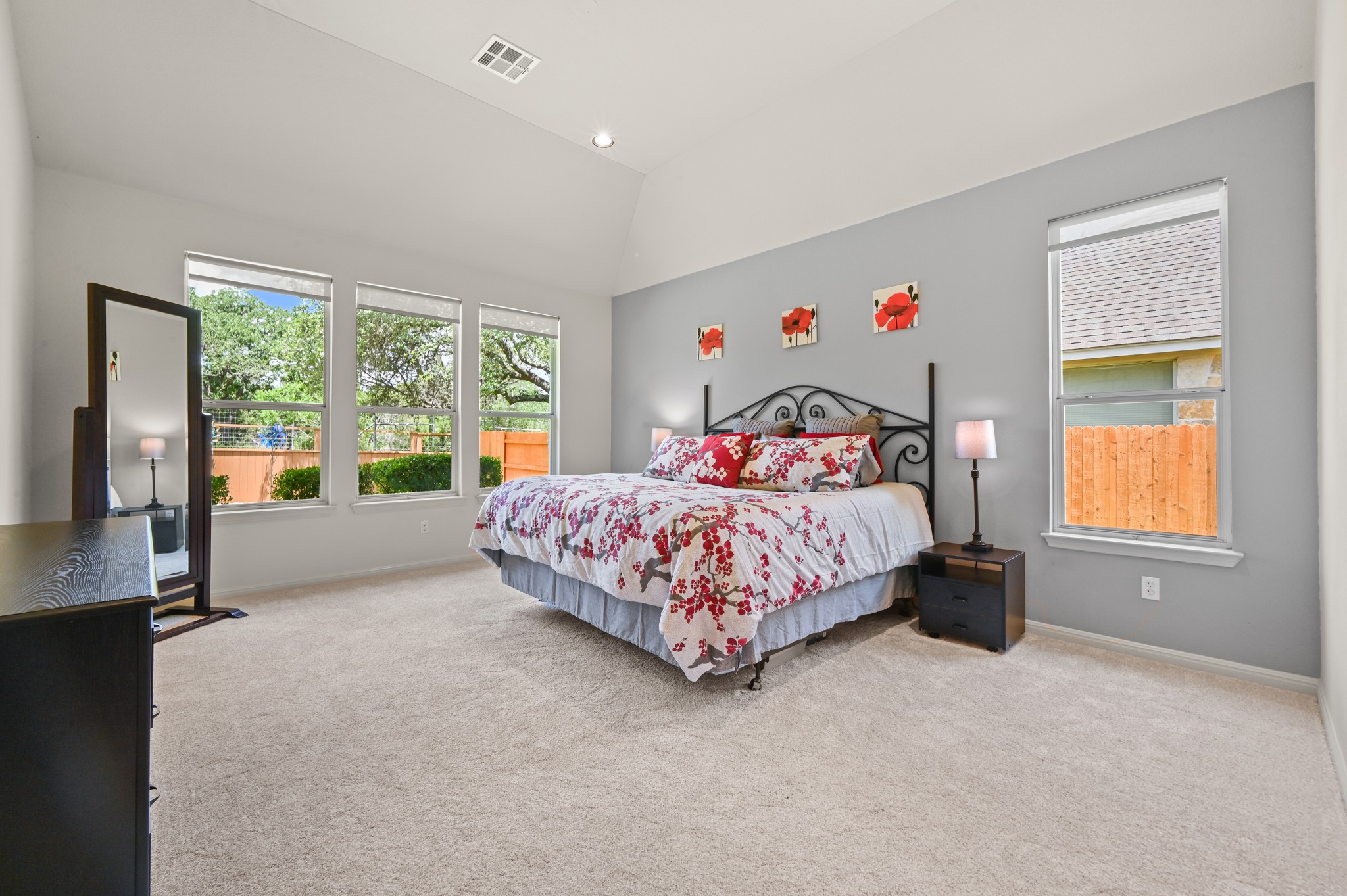7301 Seneca Falls Loop Austin, TX 78739 - Photo 17 of 36 The spacious primary bedroom is so relaxing with the large windows overlooking the backyard and greenbelt.