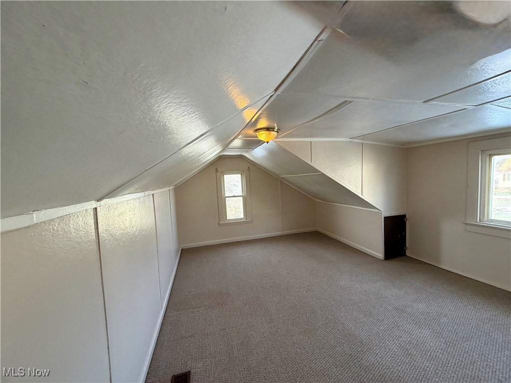 34 West Lewis Street Struthers, OH 44471 - Photo 8 of 14 Bonus room featuring lofted ceiling, carpet floors, and a textured ceiling