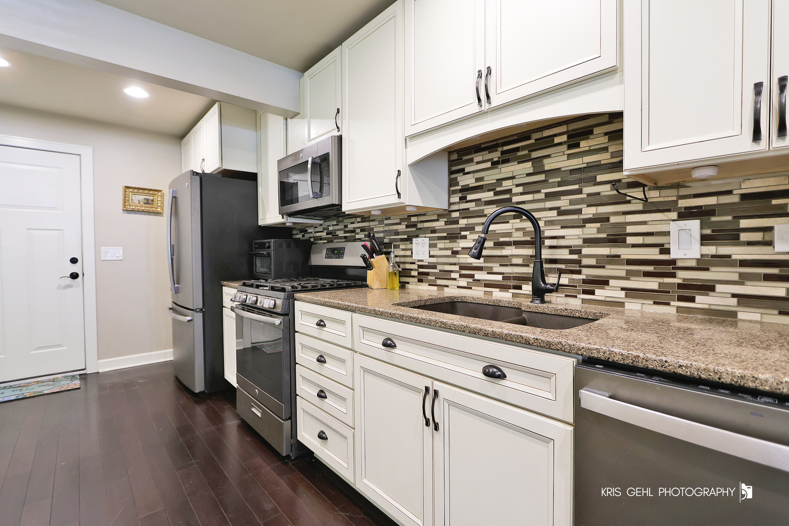 5310 Oak Park Road Oakwood Hills, IL 60013 - Photo 7 of 17 a kitchen with stainless steel appliances kitchen island granite countertop a stove a sink and a refrigerator