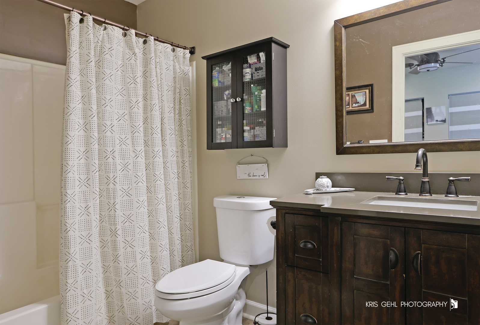 5310 Oak Park Road Oakwood Hills, IL 60013 - Photo 10 of 17 a bathroom with a toilet a sink a mirror a shower curtain