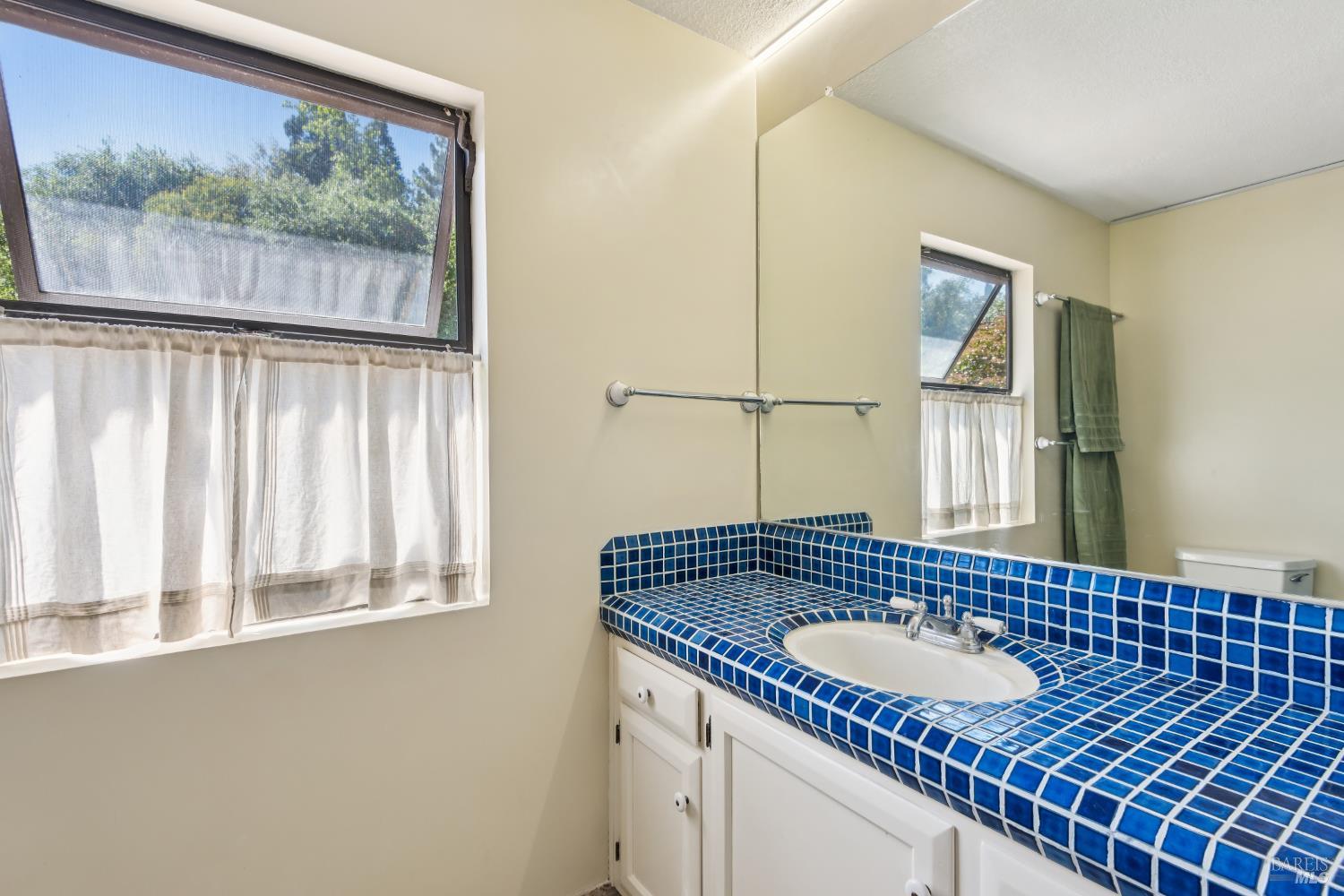 1475 Los Olivos Road Santa Rosa, CA 95404 - Photo 29 of 51 a bathroom with a granite countertop sink and a window
