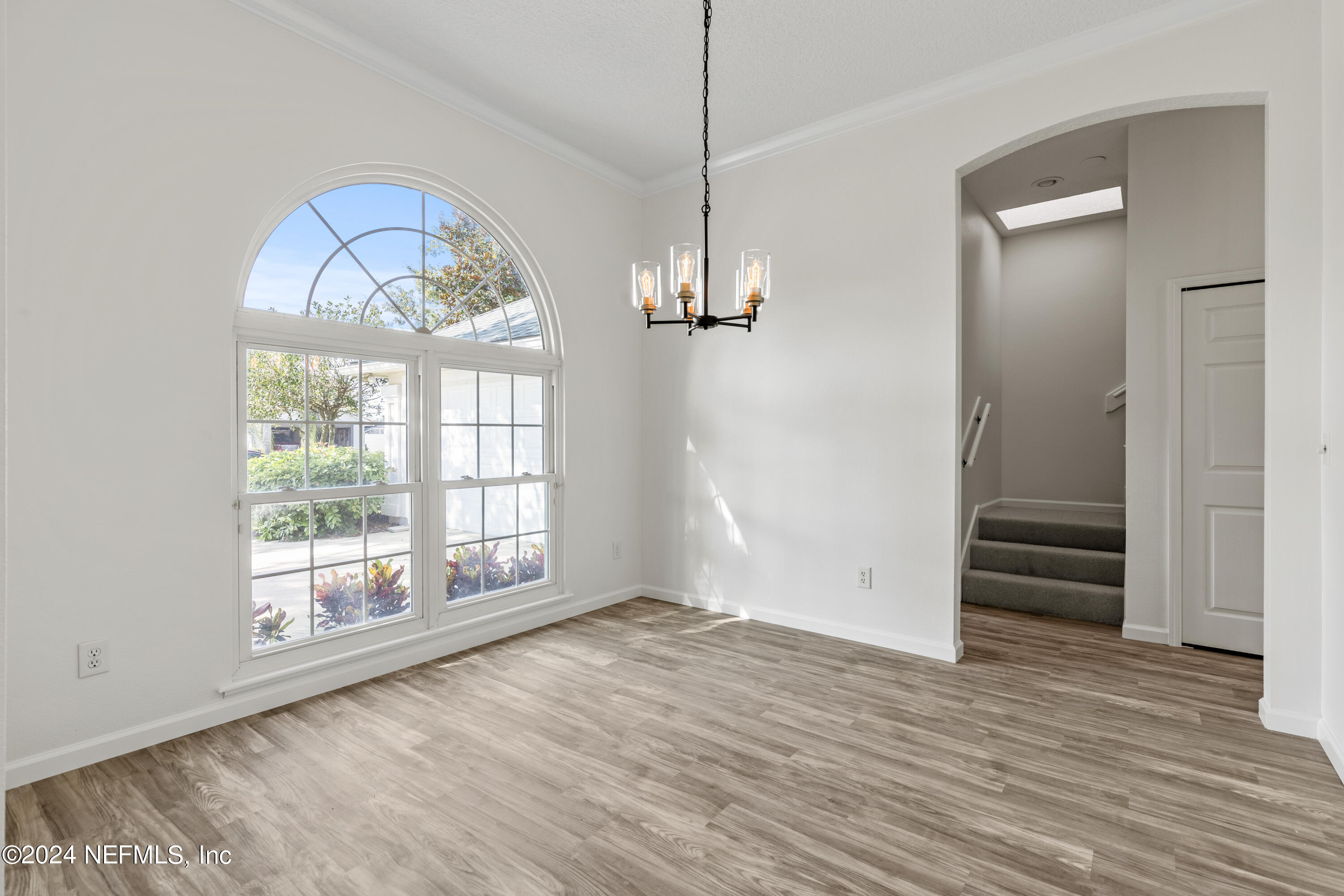 156 Bilbao Drive St. Augustine, FL 32086 - Photo 11 of 57 wooden floor in an empty room with a window