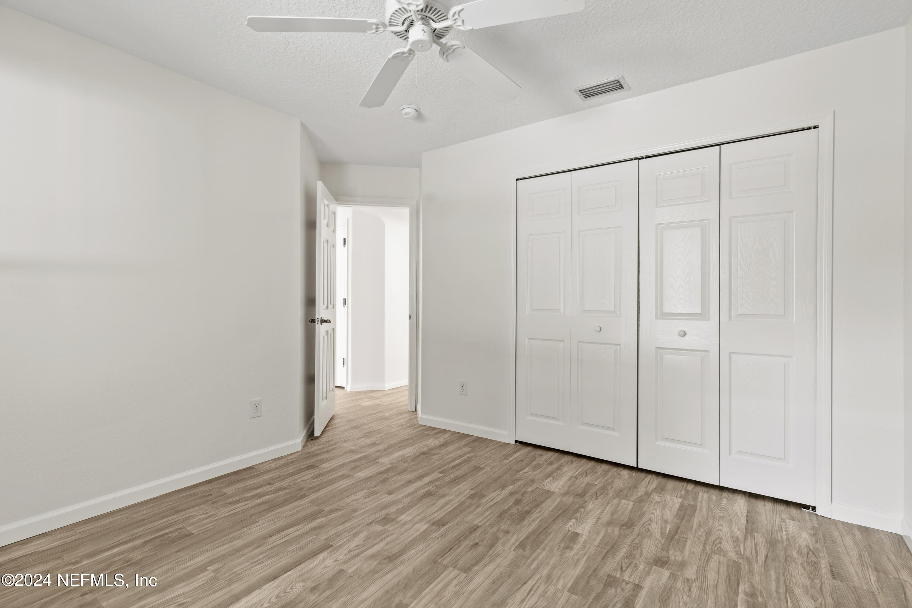 156 Bilbao Drive St. Augustine, FL 32086 - Photo 30 of 57 a view of an empty room with wooden floor